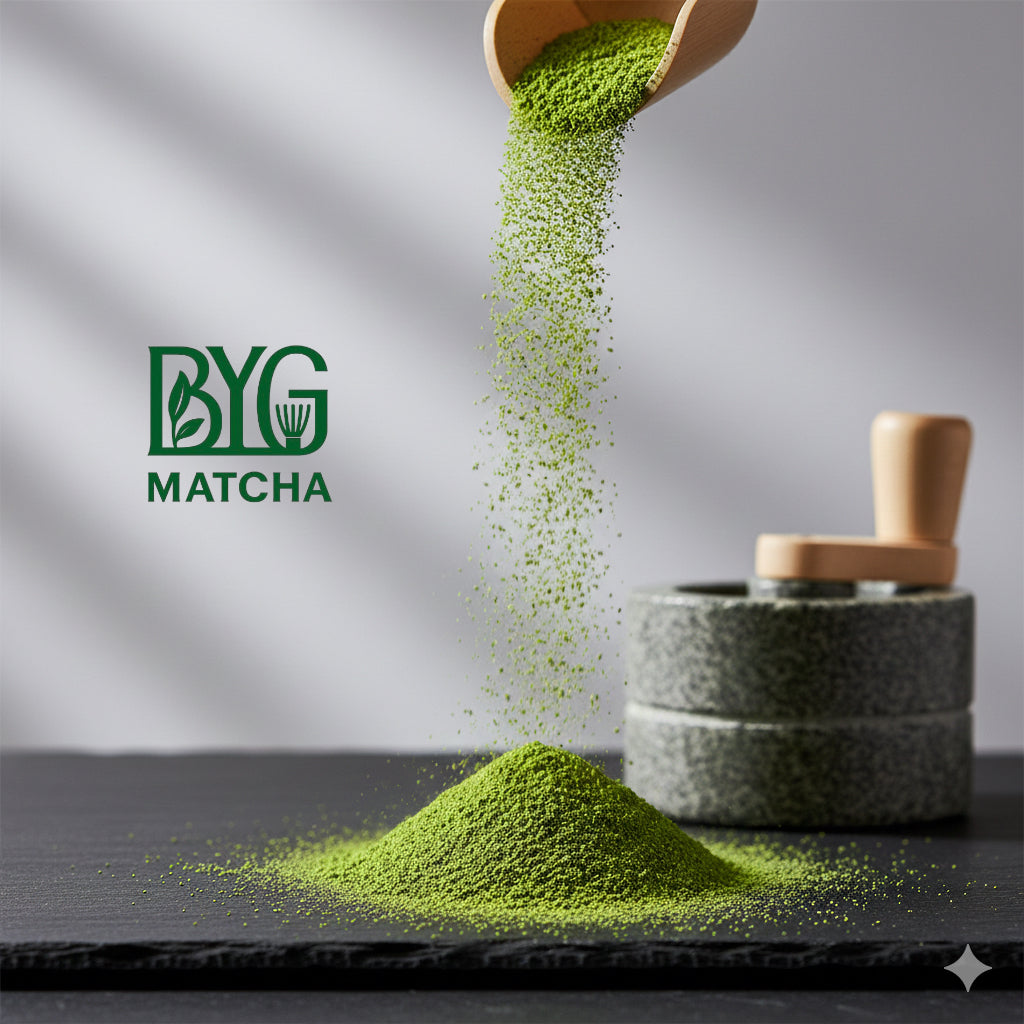Matcha powder being poured from a wooden scoop onto a stone grinder with BYG Matcha logo.